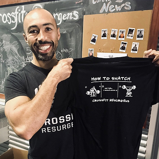 Man holding up a Terminus-designed B+C tshirt