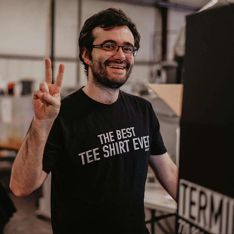 Terminus Tees team member flashing a peace sign