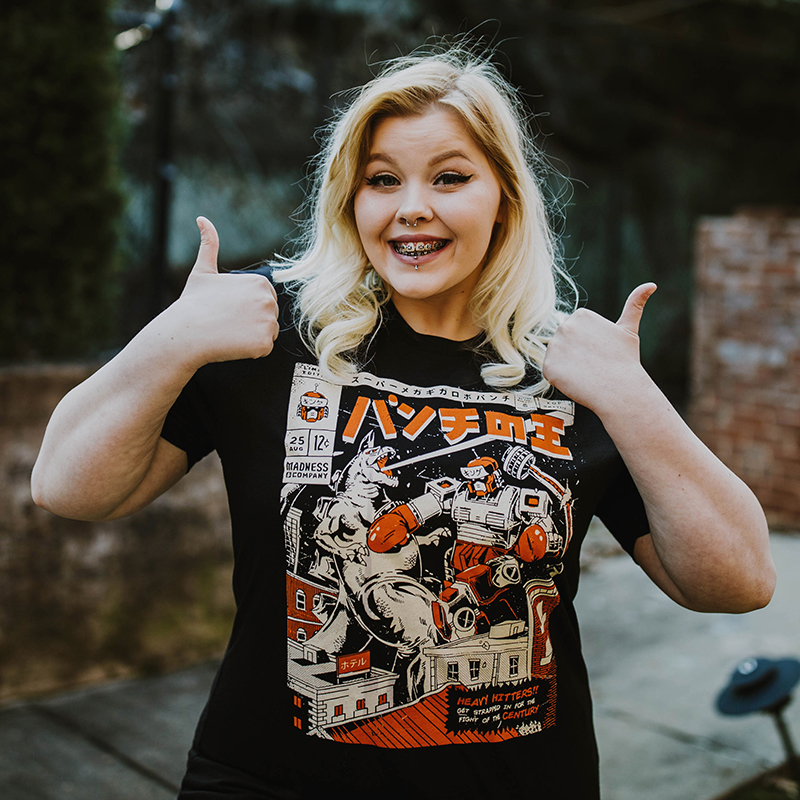 Smiling woman posing outside with two thumbs up